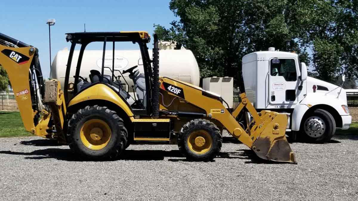 septic services truck and backhoe